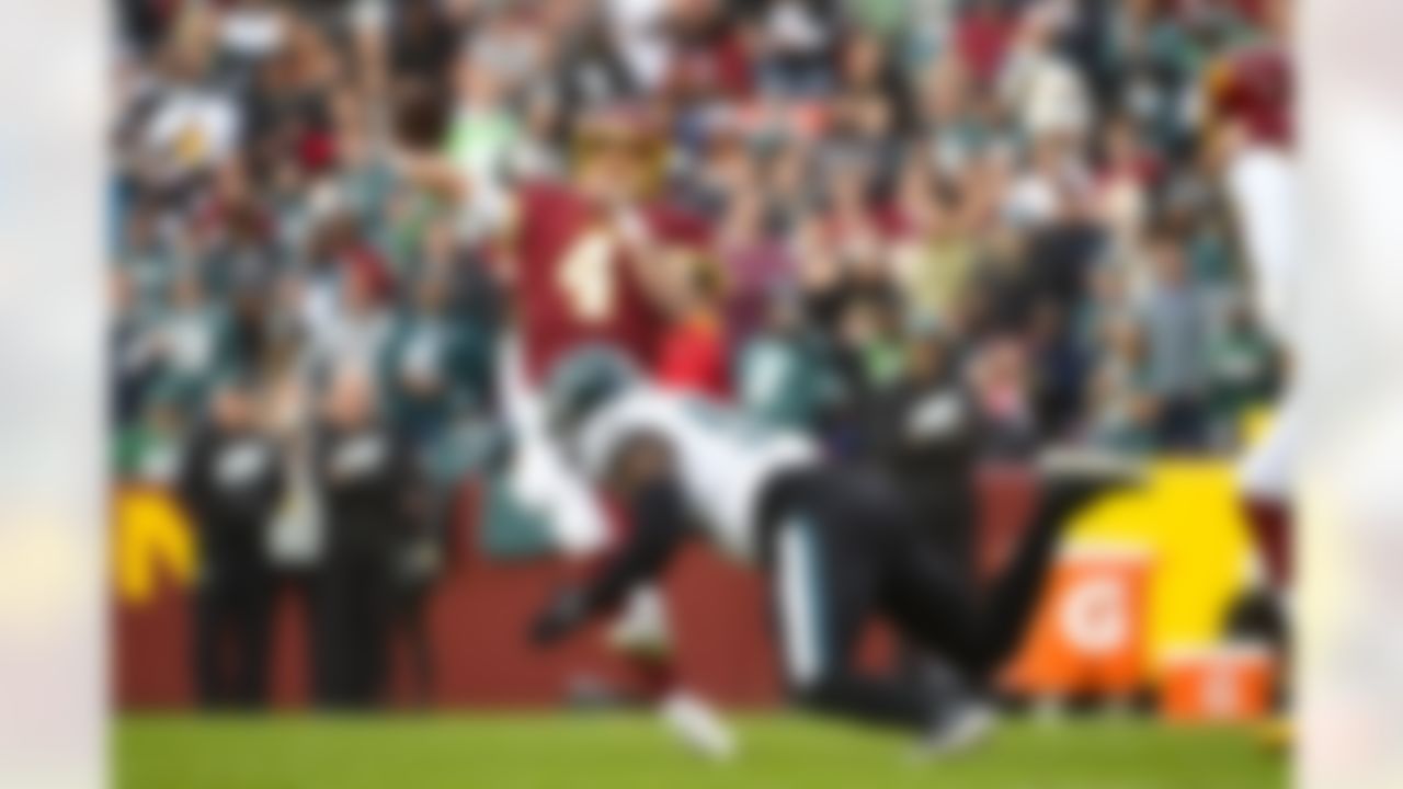 Washington Football Team quarterback Taylor Heinicke (4) throwing the ball while being rushed by Philadelphia Eagles defensive end Milton Williams (93) during the first half of an NFL football game, Sunday, Jan. 2, 2022, in Landover, Md.