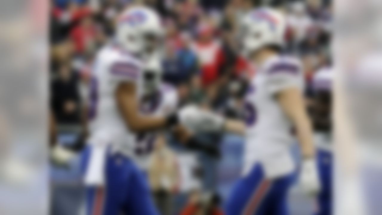 Buffalo Bills wide receiver Robert Woods, left, celebrates his touchdown catch with Chris Hogan in the first half of an NFL football game against the New England Patriots, Sunday, Dec. 28, 2014, in Foxborough, Mass. (AP Photo/Charles Krupa)