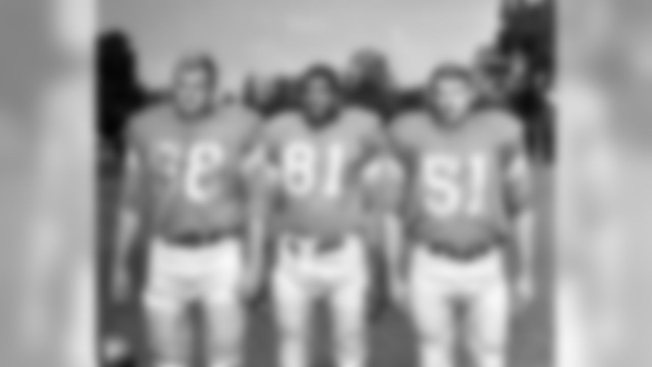 Center Jerry Archer (58), left, defensive halfback Dick Lane (81), and center Bob Whitelow (51), right, pose at the Detroit Lions Professional Football team's training camp in Bloomfield Hills, Mich., July 29, 1963. (AP Photo/Alvin Quinn)