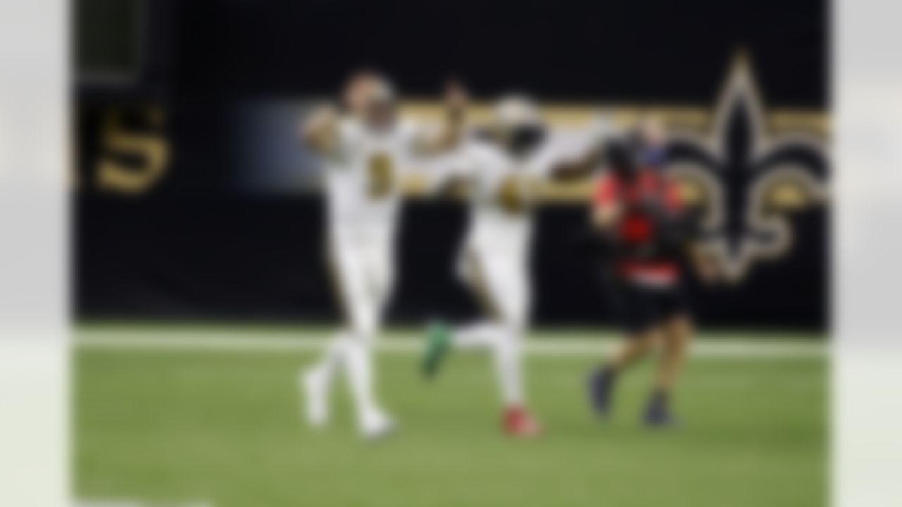 New Orleans Saints quarterback Drew Brees (9) and running back Alvin Kamara (41) celebrate during an NFL football game against the Minnesota Vikings on Friday, December 25, 2020 in New Orleans, Louisiana.