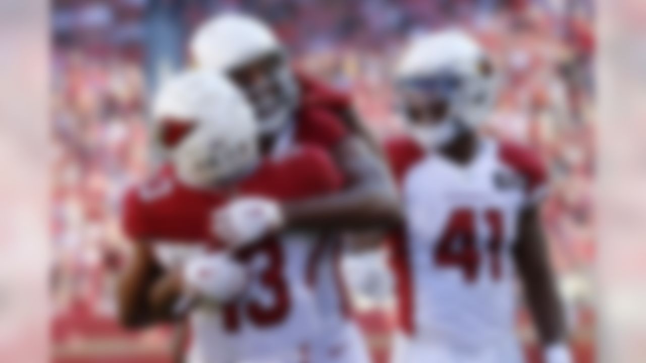 Arizona Cardinals wide receiver Larry Fitzgerald, center, celebrates with wide receiver Christian Kirk (13) and running back Kenyan Drake (41) after scoring against the San Francisco 49ers during the first half of an NFL football game in Santa Clara, Calif., Sunday, Nov. 17, 2019. (AP Photo/Josie Lepe)