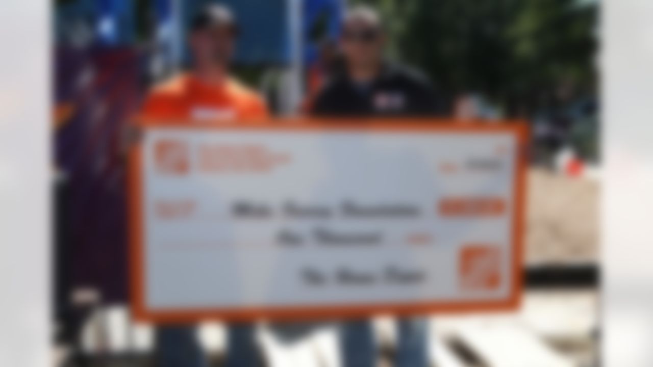 David Rock, Store Manager at The Home Depot, presents Detroit Lions wide receiver, Mike Furrey, with a donation to the Mike Furrey Foundation. (Photo by Tom Copeland/Home Depot)