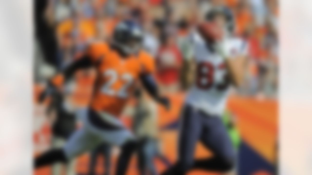 Houston Texans wide receiver Kevin Walter (83) catches a pass against Denver Broncos cornerback Tracy Porter (22) for a touchdown in the second quarter of an NFL football game Sunday, Sept. 23, 2012, in Denver. (AP Photo/Jack Dempsey)