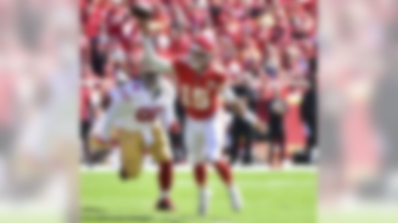 Kansas City Chiefs quarterback Patrick Mahomes (15) throws a pass as he runs away from San Francisco 49ers defensive lineman Sheldon Day (96) during the first half of an NFL football game in Kansas City, Mo., Sunday, Sept. 23, 2018. (AP Photo/Ed Zurga)