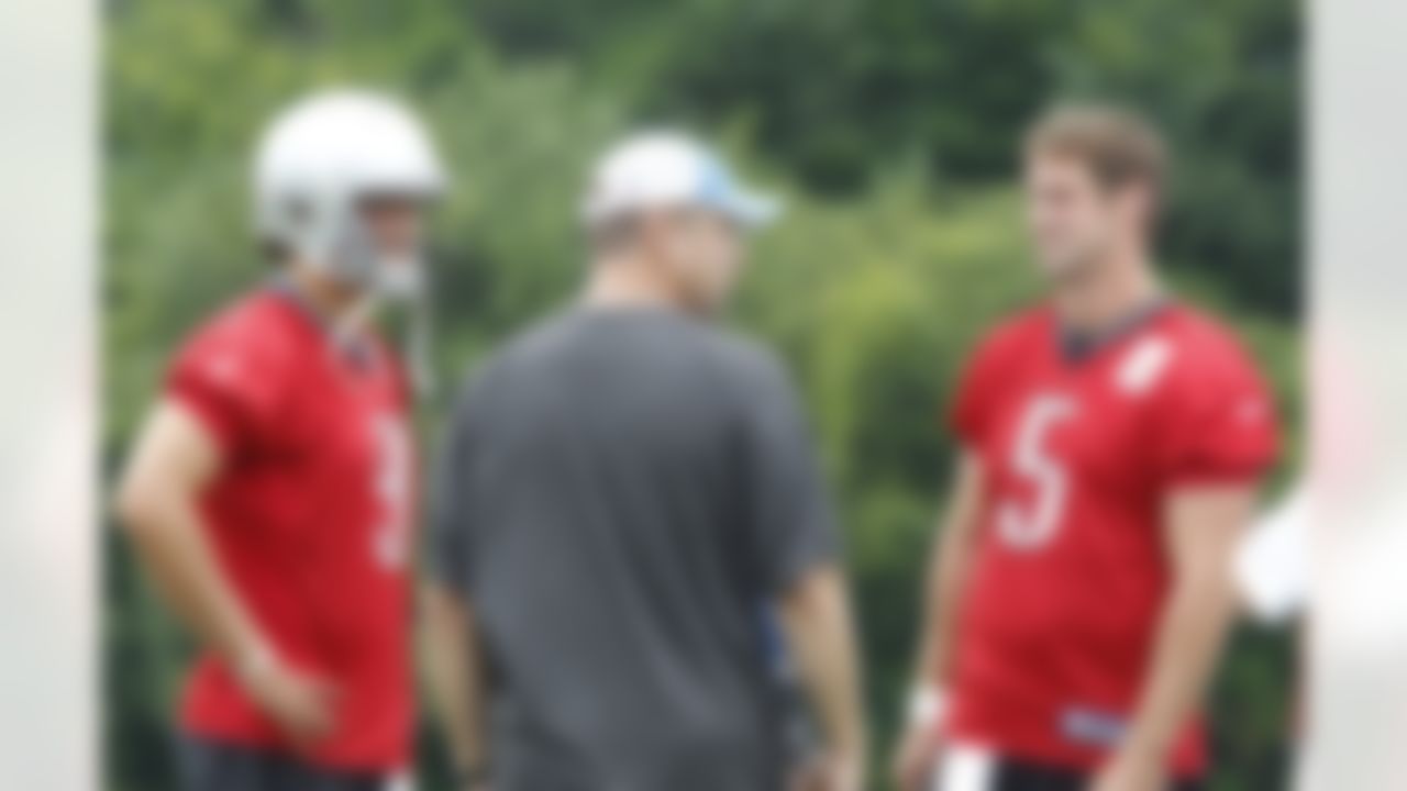 Detroit Lions offensive coordinator Scott Linehan, center, talks with quarterbacks Matthew Stafford (9) and Drew Stanton before the start of NFL football training camp in Allen Park, Mich., Saturday, July 31, 2010. (AP Photo/Carlos Osorio)