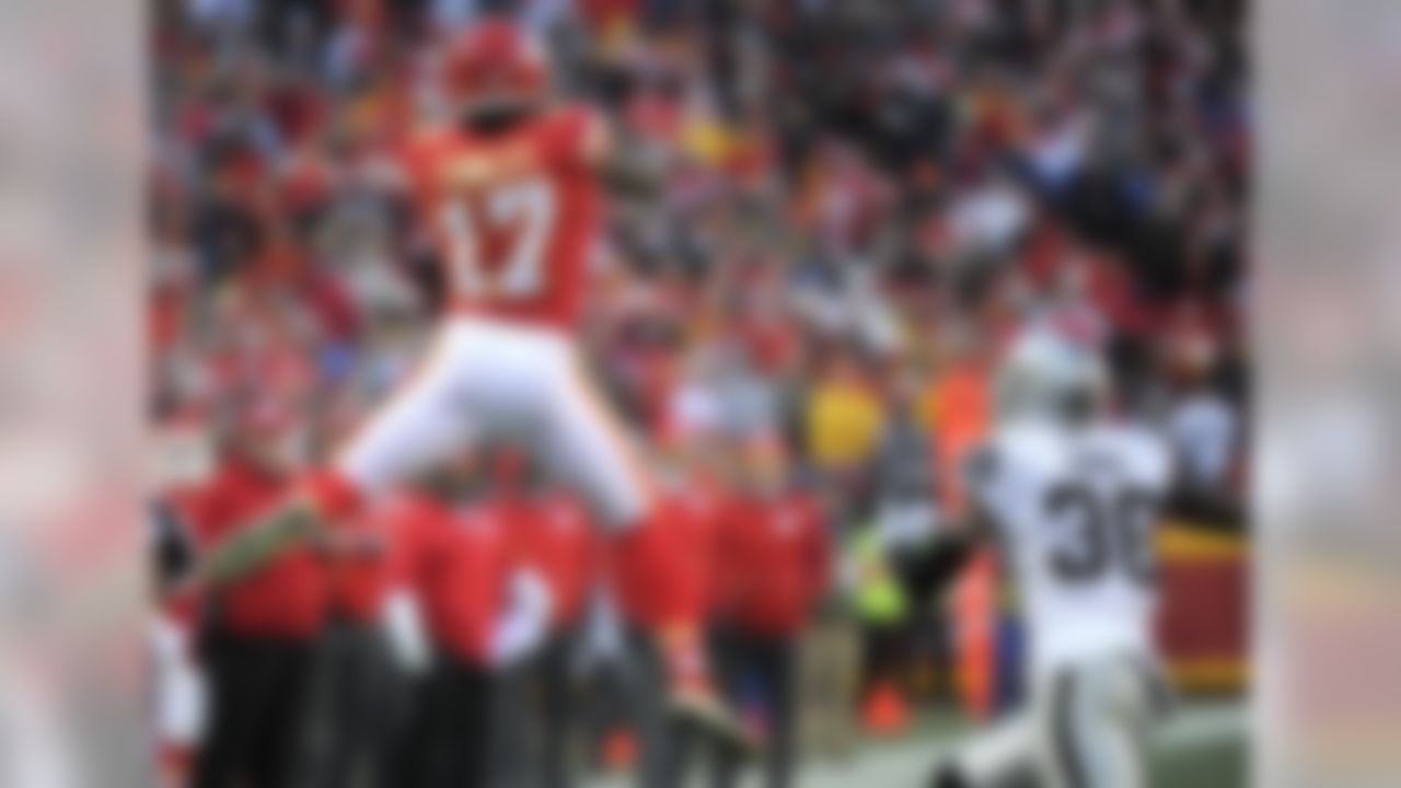 Kansas City Chiefs wide receiver Chris Conley (17) makes a catch against Oakland Raiders cornerback TJ Carrie (38) during the first half of an NFL football game in Kansas City, Mo., Sunday, Jan. 3, 2016. (AP Photo/Ed Zurga)