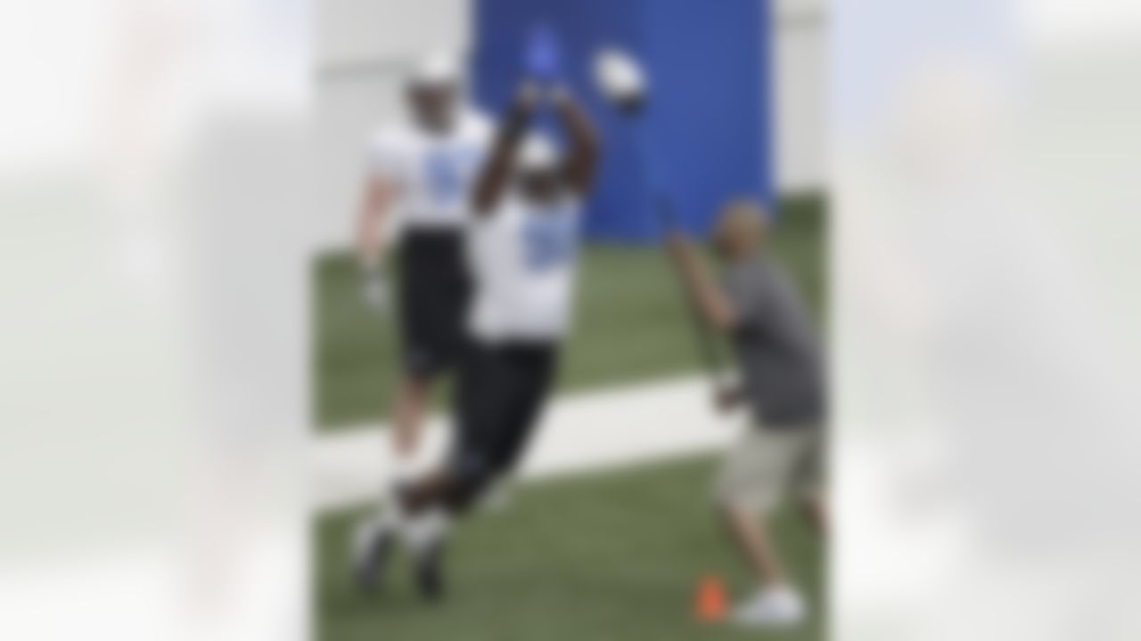 Detroit Lions defensive tackle Nick Fairley (98) runs a drill as Kyle Vanden Bosch (93) watches during their NFL football training camp practice at the teams indoor training facility in Allen Park, Mich., Friday, July 29, 2011. (AP Photo/Paul Sancya)