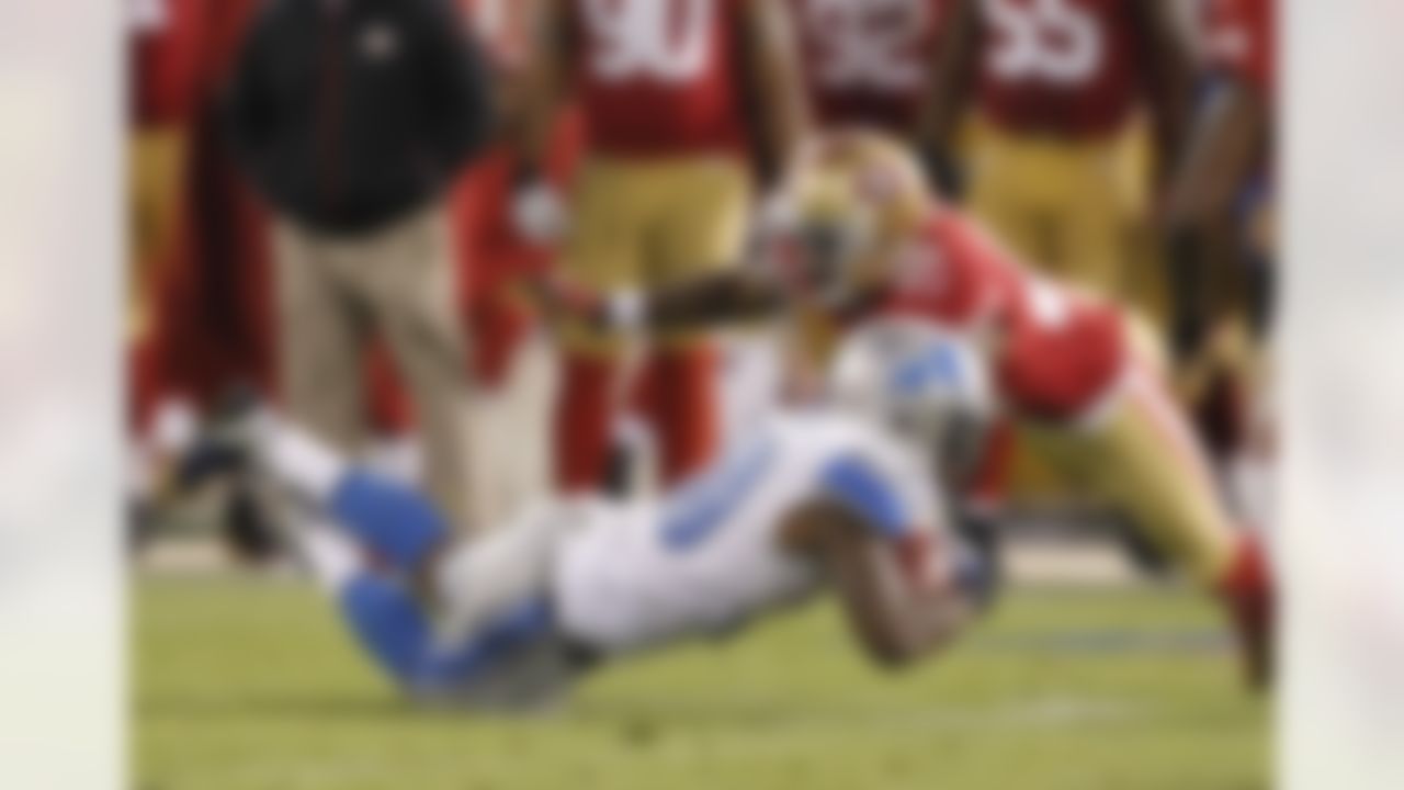 Detroit Lions running back Kevin Smith, left, is brought down with the ball by San Francisco 49ers defensive back Perrish Cox during the fourth quarter of an NFL football game in San Francisco, Sunday, Sept. 16, 2012. (AP Photo/Tony Avelar)