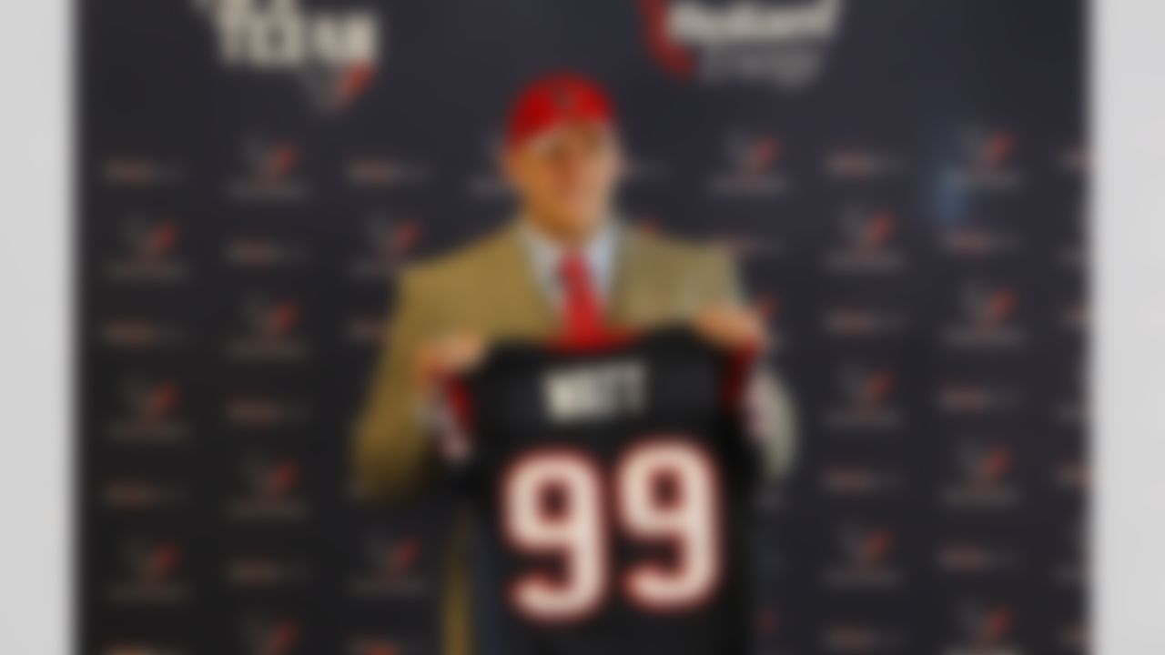 Houston Texans first-round draft pick J.J. Watt holds up his jersey for a photo during an NFL football news conference at Reliant Stadium on Friday April 29, 2011 in Houston, Texas. (AP Photo/Aaron M. Sprecher)