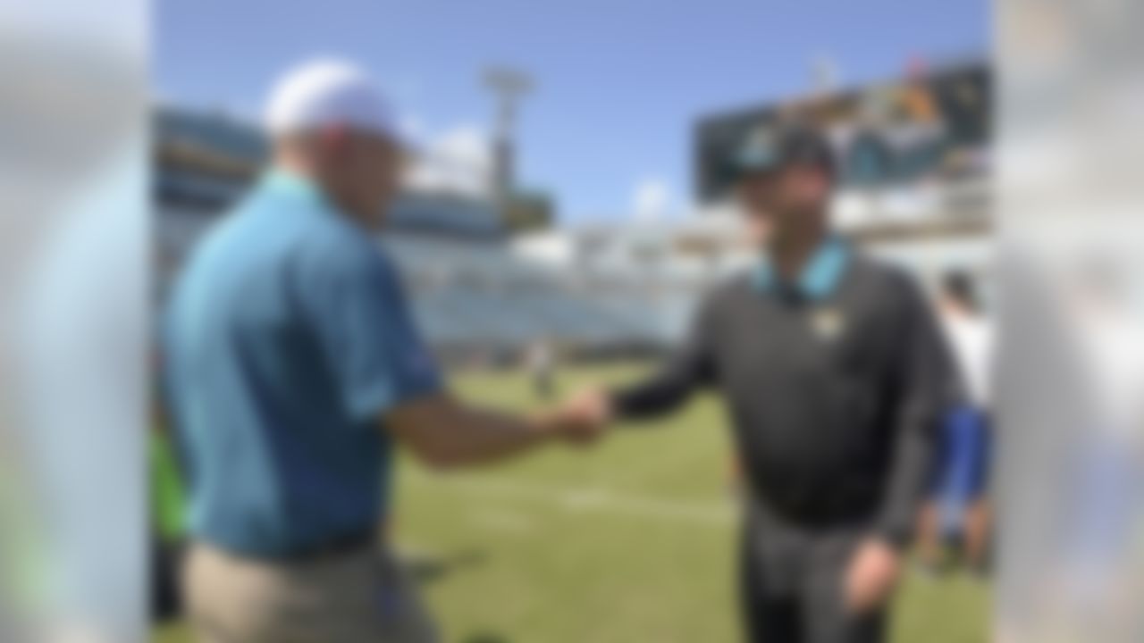 Miami Dolphins head coach Joe Philbin, left, greets Jacksonville Jaguars head coach Gus Bradley before an NFL football game in Jacksonville, Fla., Sunday, Sept. 20, 2015.(AP Photo/Phelan M. Ebenhack)