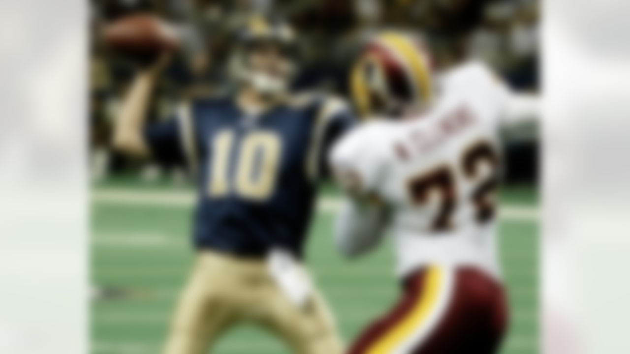 St. Louis Rams quarterback Marc Bulger sets to pass while under pressure from Washington Redskins' Nic Clemons (72) in the second quarter of an NFL preseason game in St. Louis on Friday, Aug. 27, 2004. Bulger completed the pass to Torry Holt for a 7-yard touchdown. (AP Photo/James A. Finley)