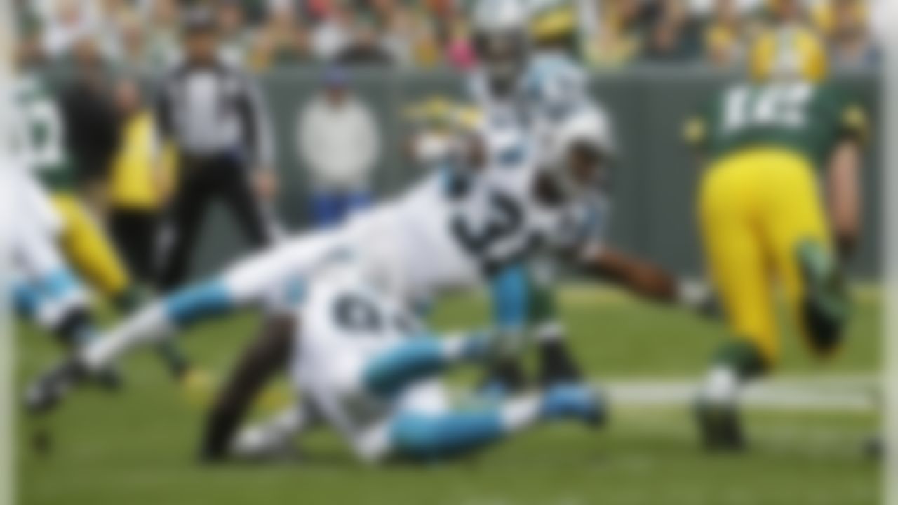 Green Bay Packers' Aaron Rodgers runs for a first down during the first half of an NFL football game against the Carolina Panthers Sunday, Oct. 19, 2014, in Green Bay, Wis. (AP Photo/Morry Gash)