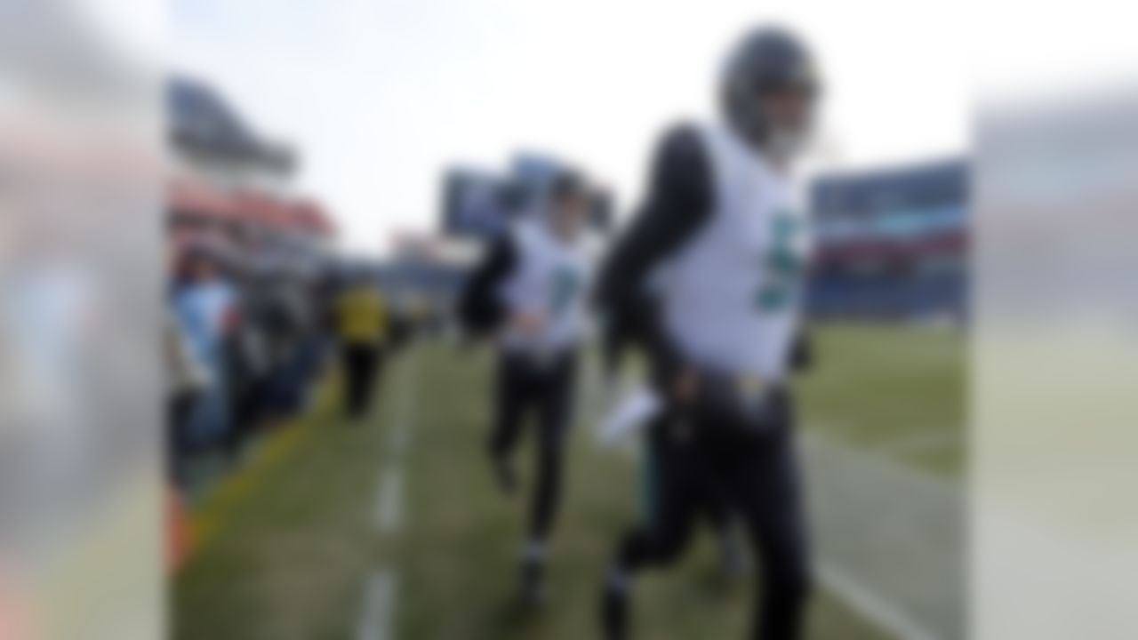 Jacksonville Jaguars quarterbacks Blake Bortles (5) and Chad Henne (7) run to the locker room after warming up before an NFL football game against the Tennessee Titans Sunday, Dec. 31, 2017, in Nashville, Tenn. (AP Photo/Mark Zaleski)