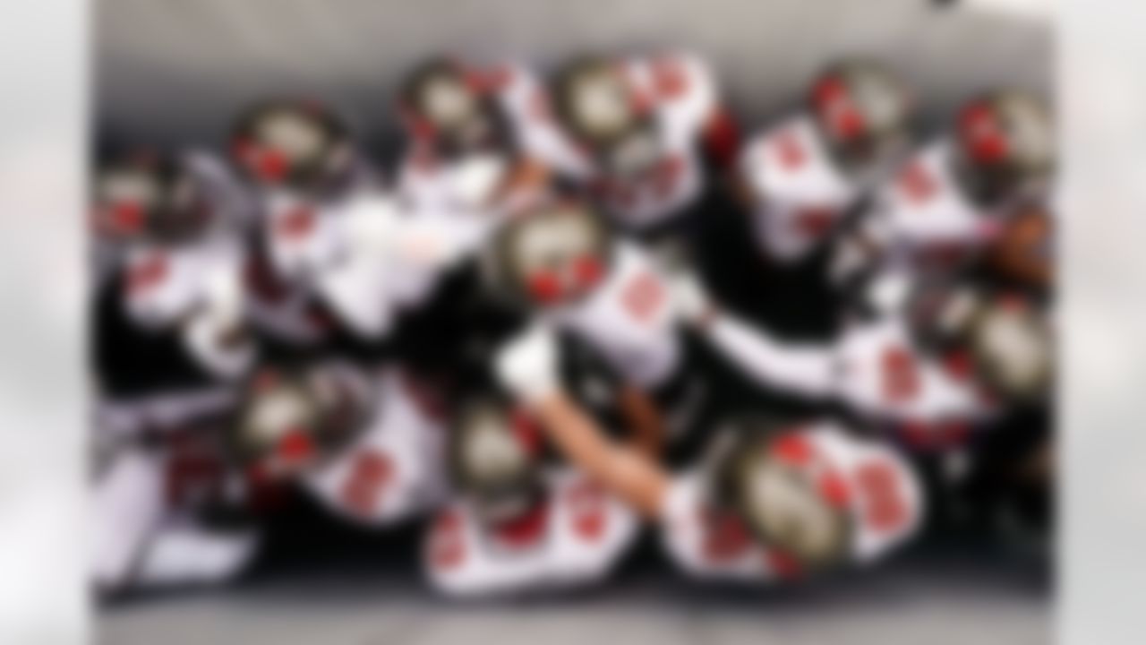 The Tampa Bay Buccaneers huddle in a walkway to Lambeau Field in Green Bay before Sunday's NFC Championship Game.