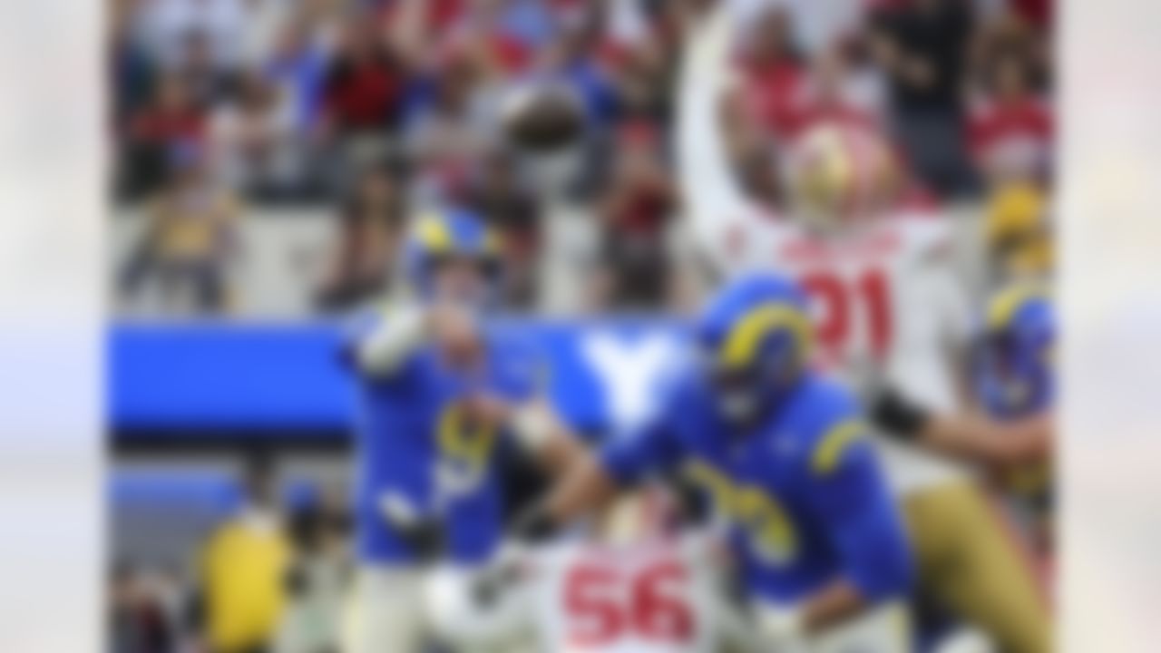 Los Angeles Rams quarterback Matthew Stafford (9) throws a pass through defenders during an NFL football game against the San Francisco 49ers on Sunday, January 9, 2022 in Inglewood, California.