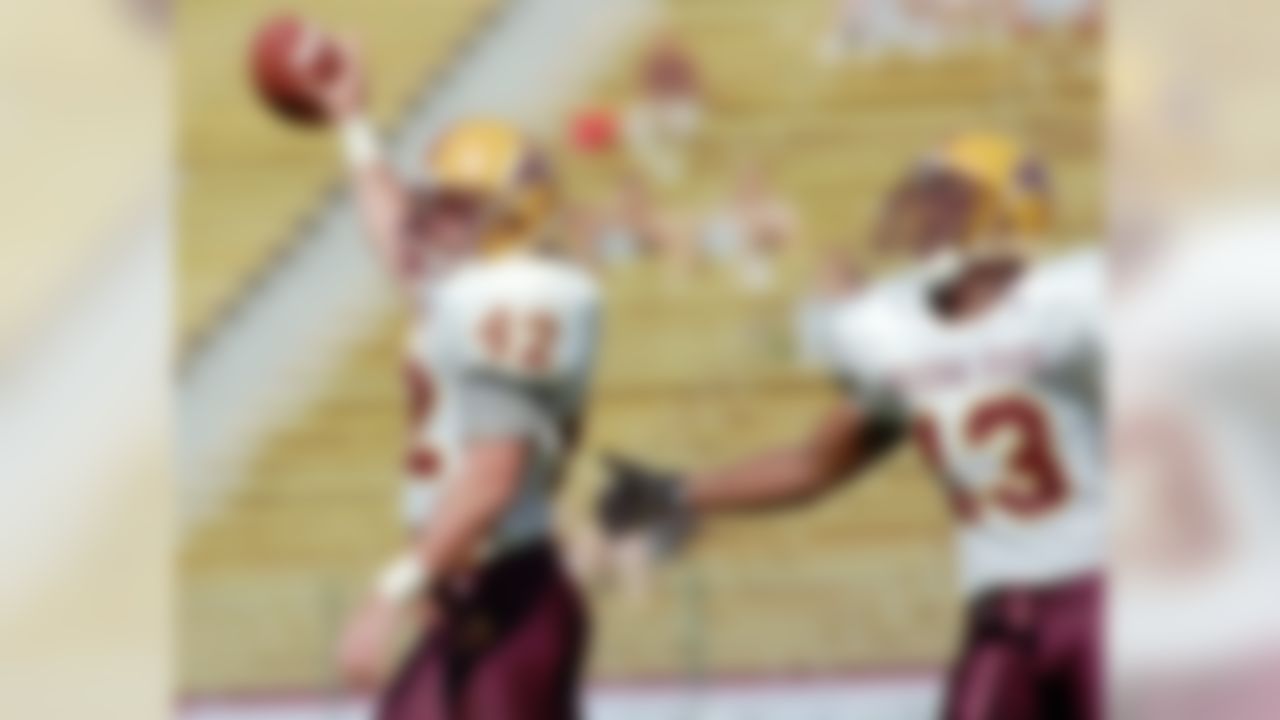 Arizona State linebacker Pat Tillman, left, holds up the ball as he is congratulated by free safety Mitchell Freedman, right, after Tillman intercepted a pass by Stanford quarterback Chad Hutchinson during the second quarter of an NCAA college football game at Stanford, Calif., Stadium on Oct. 18, 1997. (AP Photo/Paul Sakuma, File)