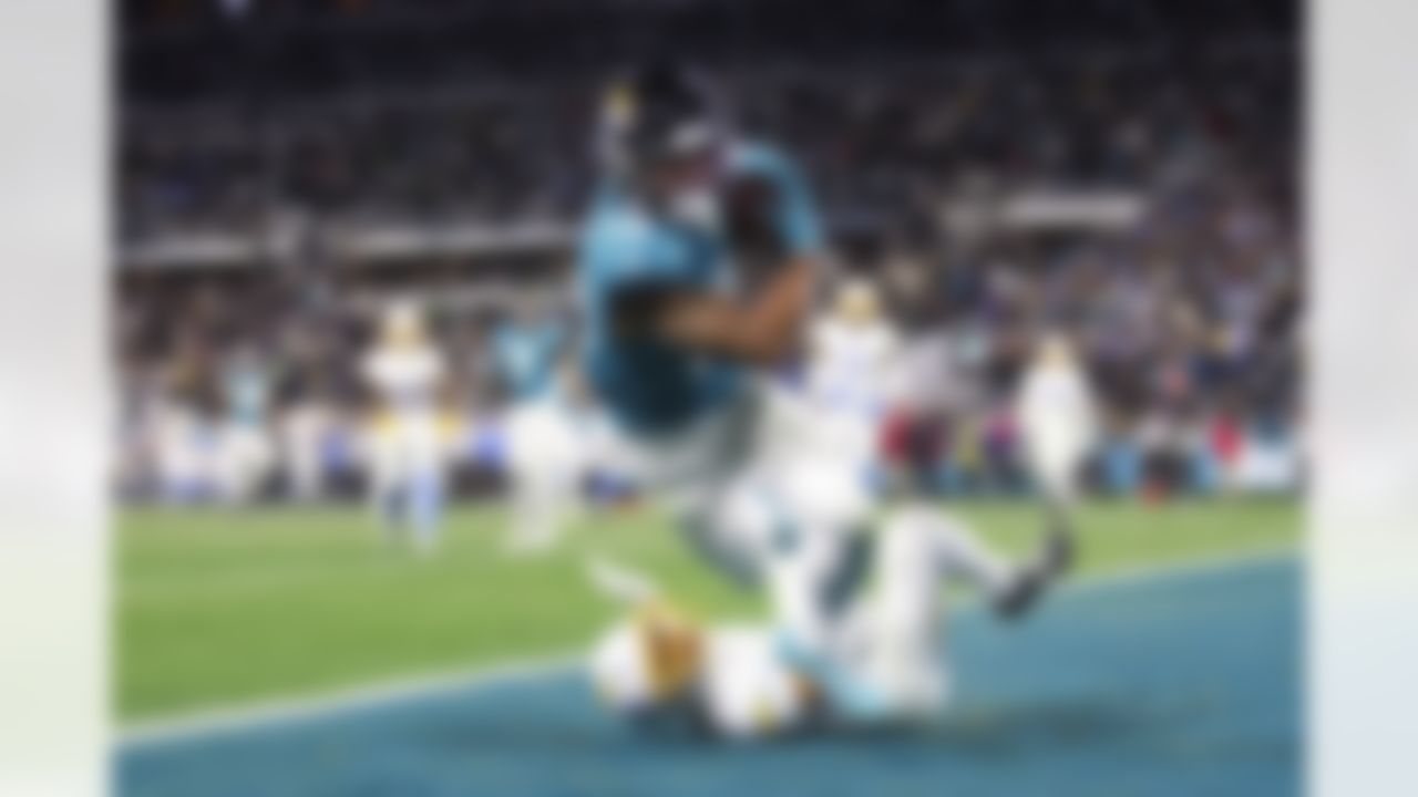 Jacksonville Jaguars wide receiver Christian Kirk (13) makes a catch in the end zone during an NFL Super Wild Card Weekend playoff game against the Los Angeles Chargers on Saturday, January 14, 2023 in Jacksonville, Florida.