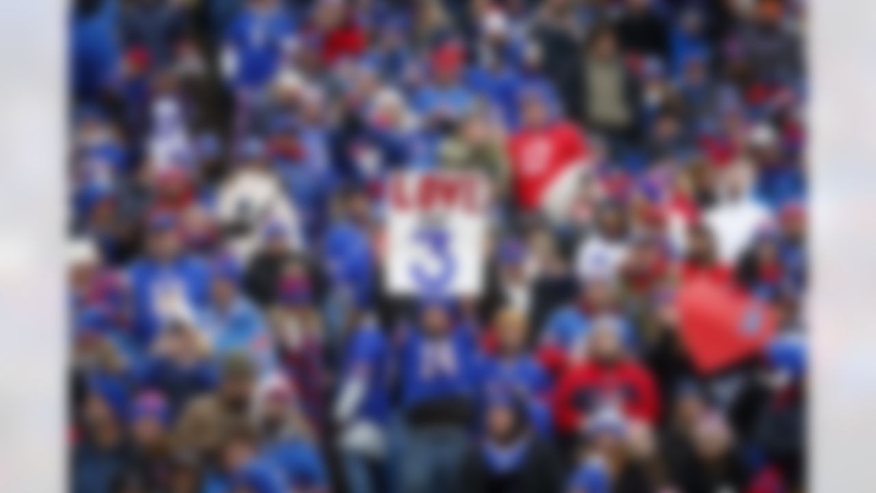 Fans hold signs in support of safety Damar Hamlin before an NFL football game against the New England Patriots, Sunday, Jan. 8, 2023, in Orchard Park, N.Y. Hamlin remains hospitalized after suffering a catastrophic on-field collapse in the team's previous game against the Cincinnati Bengals.