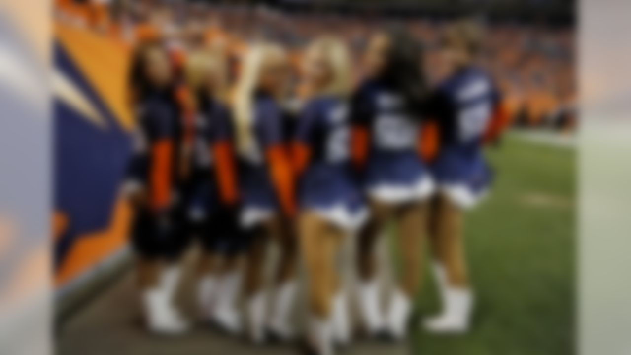 the Denver Broncos cheerleaders wear "509" t-shirts after Peyton Manning threw his 509th career touchdown pass during the first half of an NFL football game against the San Francisco 49ers , Sunday, Oct. 19, 2014, in Denver.  (AP Photo/Jack Dempsey)