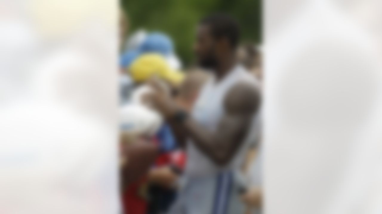 Detroit Lions receiver Calvin Johnson signs autographs after practice at NFL football training camp in Allen Park, Mich., Tuesday, Aug. 2, 2011. (AP Photo/Carlos Osorio)