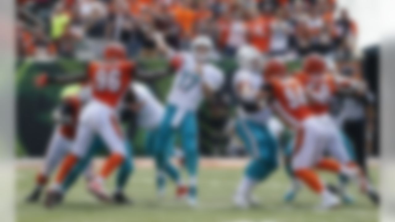 Cincinnati Bengals defensive end Carlos Dunlap (96) pressures Miami Dolphins quarterback Ryan Tannehill (17) during the first half of an NFL football game in Cincinnati, Sunday, Oct. 7, 2018. (AP Photo/Gary Landers)