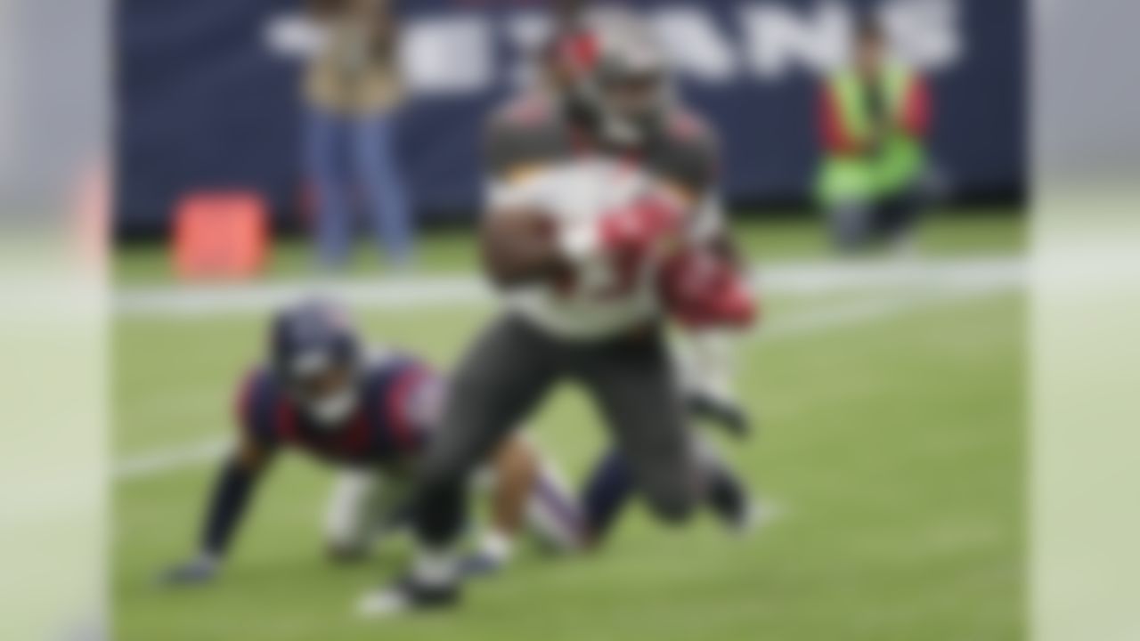 Tampa Bay Buccaneers' Bobby Rainey (43) runs past Houston Texans' Kevin Johnson (30) during the first half of an NFL football game Sunday, Sept. 27, 2015, in Houston. (AP Photo/David J. Phillip)