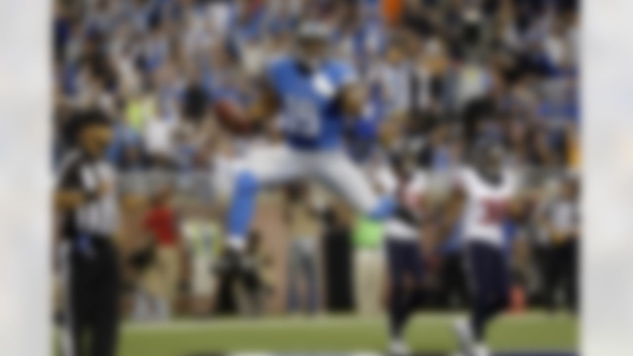 Detroit Lions receiver Mike Thomas celebrates his 5-yard touchdown reception during the second quarter of an NFL football game against the Houston Texans at Ford Field in Detroit, Thursday, Nov. 22, 2012. (AP Photo/Paul Sancya)