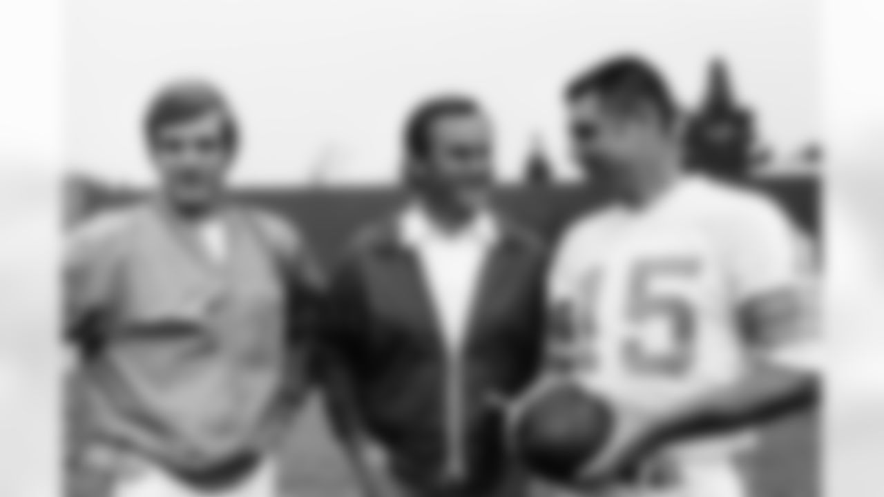 Miami Dolphins Coach Don Shula talks with quarterbacks Bob Griese, left and Earl Morrall during picture session at the Dolphins' practice field in Long Beach California on Monday, Jan. 9, 1973. (Associated Press)