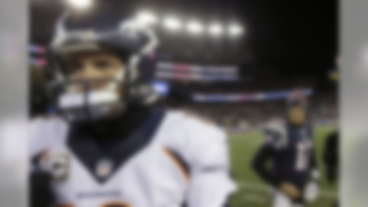 Denver Broncos quarterback Peyton Manning, left, walks from New England Patriots quarterback Tom Brady after an NFL football game early Monday, Nov. 25, 2013, in Foxborough, Mass. The Patriots won 34-31 in overtime. (AP Photo/Steven Senne)