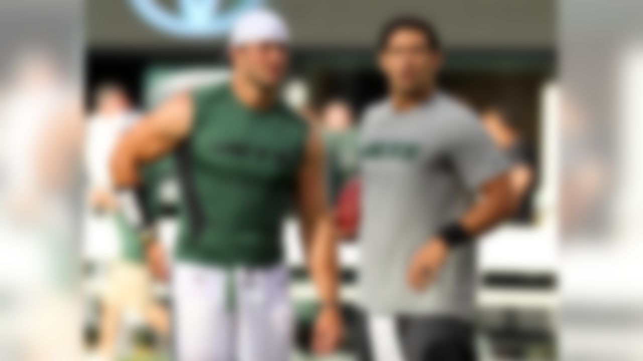 August 18, 2012; East Rutherford, NJ, USA; New York Jets quarterbacks Tim Tebow (left) and Mark Sanchez (right) talk during warmups before a preseason game against the New York Giants at MetLife Stadium. Mandatory Credit: Brad Penner-US PRESSWIRE