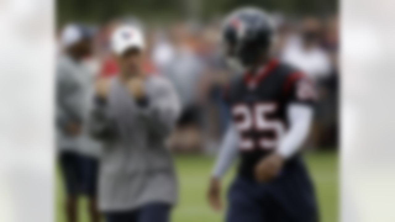 Houston Texans cornerback Kareem Jackson (25) listens to defensive backs coach David Gibbs, left,  during NFL football training camp, Saturday, July 31, 2010 in Houston. (AP Photo/David J. Phillip)