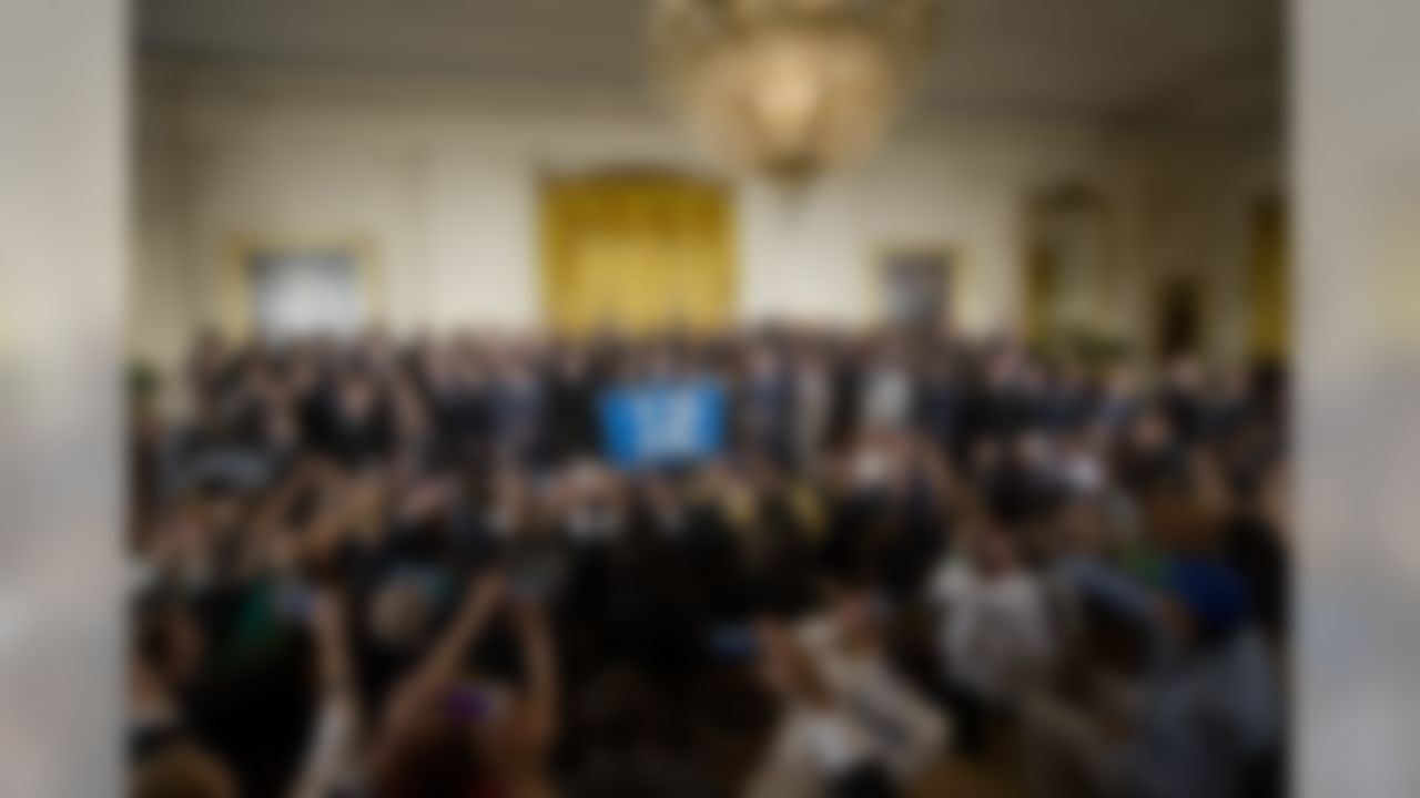 President Barack Obama poses with a banner with a "12" as he welcomes the NFL Super Bowl champion Seattle Seahawks football team to the East Room of the White House in Washington, Wednesday, May 21, 2014. The Seahawks defeated the Denver Broncos in Super Bowl XLVIII. (Pablo Martinez Monsivais/Associated Press)