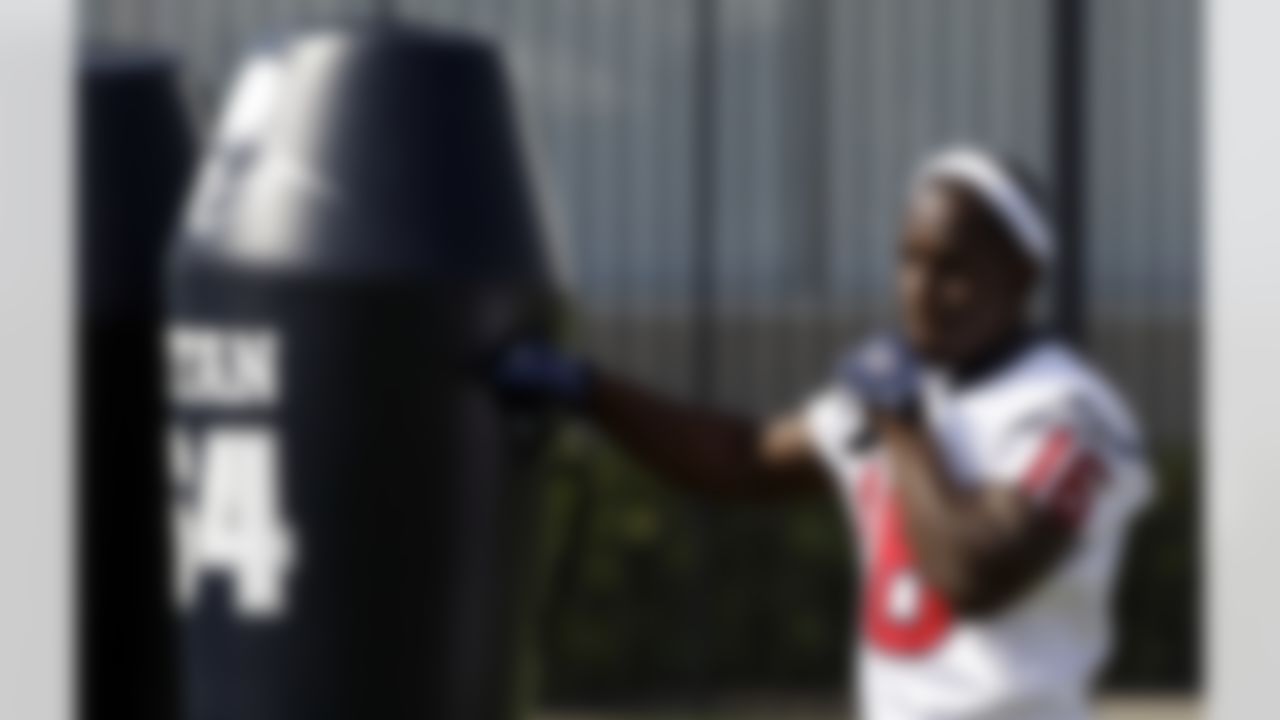Houston Texans wide receiver Trindon Holliday punches a blocking dummy before the start of an NFL football workout Wednesday, May 26, 2010, in Houston. (AP Photo/David J. Phillip)