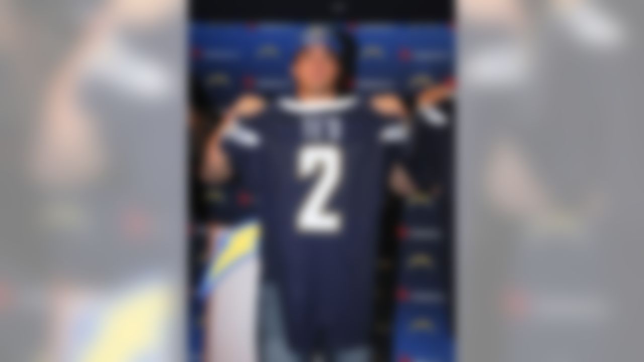 San Diego Chargers draft pick inside linebacker Manti Te'o, from Notre Dame, holds up his Chargers jersey at  an NFL football news conference at the Chargers' facility Saturday, April 27, 2013 in San Diego.  (AP Photo/Denis Poroy)