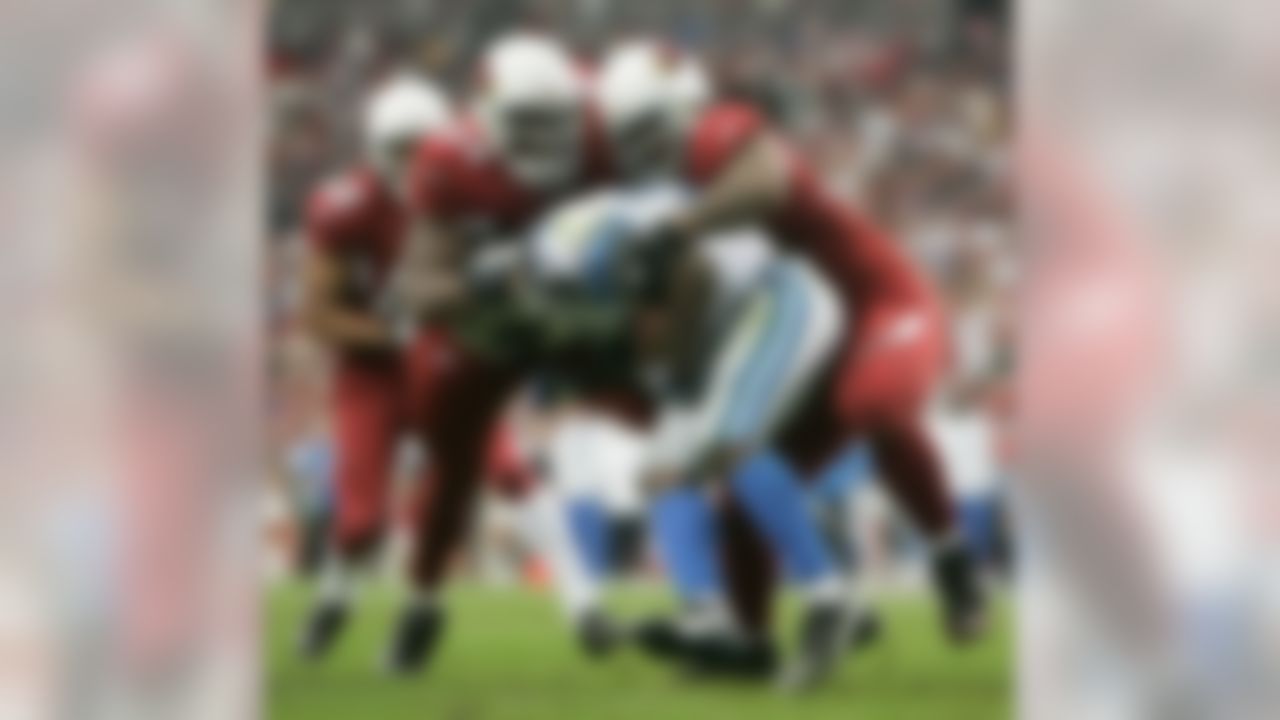 GLENDALE, AZ - NOVEMBER 11:  Antonio Smith #94 and Darnell Dockett #90 of the Arizona Cardinals team up to tackle runningback Kevin Jones #34 of the Detroit Lions in the second quarter at the University of Phoenix Stadium November 11, 2007 in Glendale, Arizona. The Cardinals defeated the Lions 31-21.  (Photo by Jeff Gross/Getty Images)