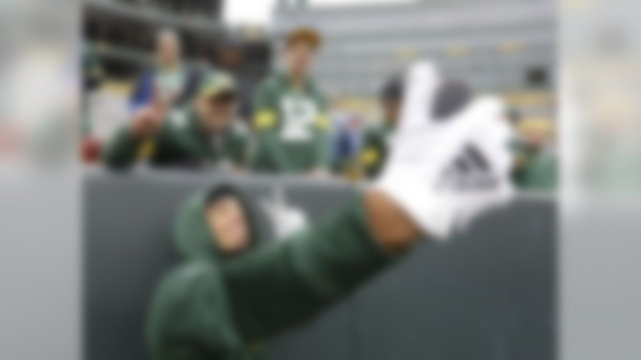 Green Bay Packers' Jaire Alexander takes a selfie with fans before an NFL football game against the Buffalo Bills Sunday, Sept. 30, 2018, in Green Bay, Wis. (AP Photo/Mike Roemer)