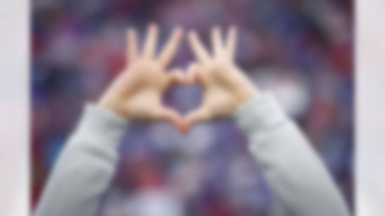 A medical professional holds up a heart and three fingers per hand in support of Buffalo Bills safety Damar Hamlin before an NFL football game against the New England Patriots, Sunday, Jan. 8, 2023, in Orchard Park, N.Y.