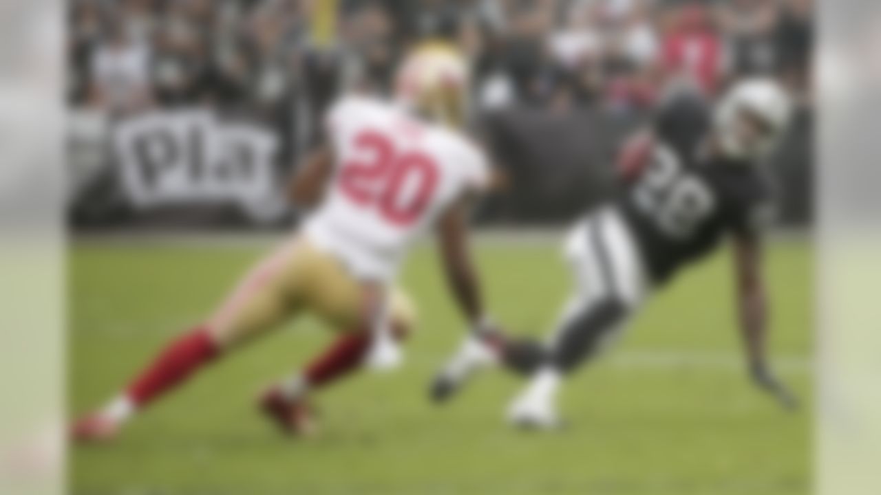 Oakland Raiders running back Latavius Murray (28) runs against San Francisco 49ers defensive back Perrish Cox (20) during the first quarter of an NFL football game in Oakland, Calif., Sunday, Dec. 7, 2014. (AP Photo/Marcio Jose Sanchez)