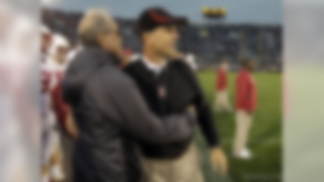 Stanford Cardinal head coach Jim Harbaugh, right, hugs his father Jack Harbaugh, as time expires against Notre Dame in an NCAA college football game in South Bend, Ind., Saturday, Sept. 25, 2010. Stanford defeated Notre Dame 37-14. (AP Photo/Michael Conroy)