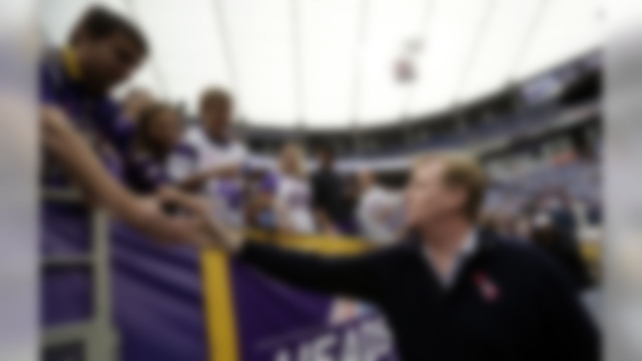 National Football League Commissioner Roger Goodell, right, greets fans before an NFL game between the Minnesota Vikings and the Tennessee Titans, Sunday, Oct. 7, 2012, in Minneapolis. (AP Photo/Charlie Neibergall)