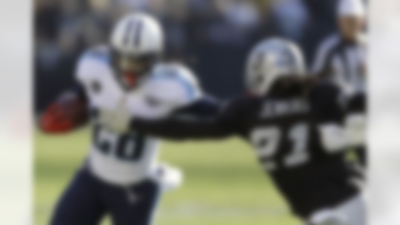 Tennessee Titans running back Chris Johnson (28) runs against Oakland Raiders cornerback Mike Jenkins (21) during the first quarter of an NFL football game in Oakland, Calif., Sunday, Nov. 24, 2013. (AP Photo/Ben Margot)