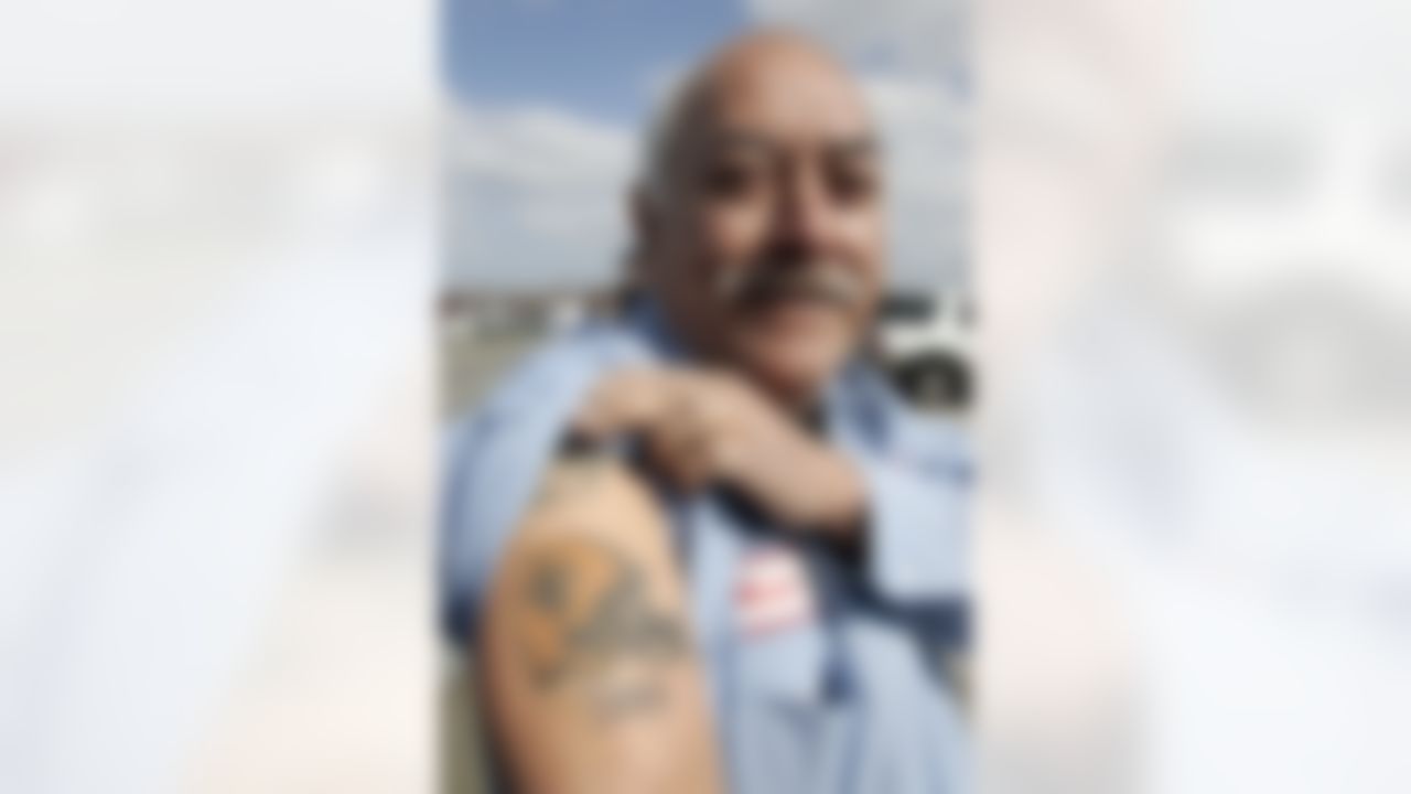 New Orleans Saints fan Mario Lara shows off his New Orleans Saints tattoo while waiting for the team to return in Kenner, LA., Monday, Feb. 8, 2010. (AP Photo/Patrick Semansky)