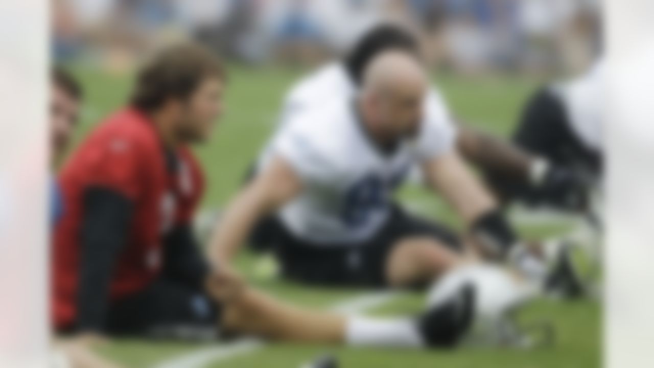 Detroit Lions quarterback Matthew Stafford, left, and defensive end Kyle Vanden Bosch stretch before running drills at NFL football training camp in Allen Park, Mich., Wednesday, Aug. 3, 2011. (AP Photo/Carlos Osorio)