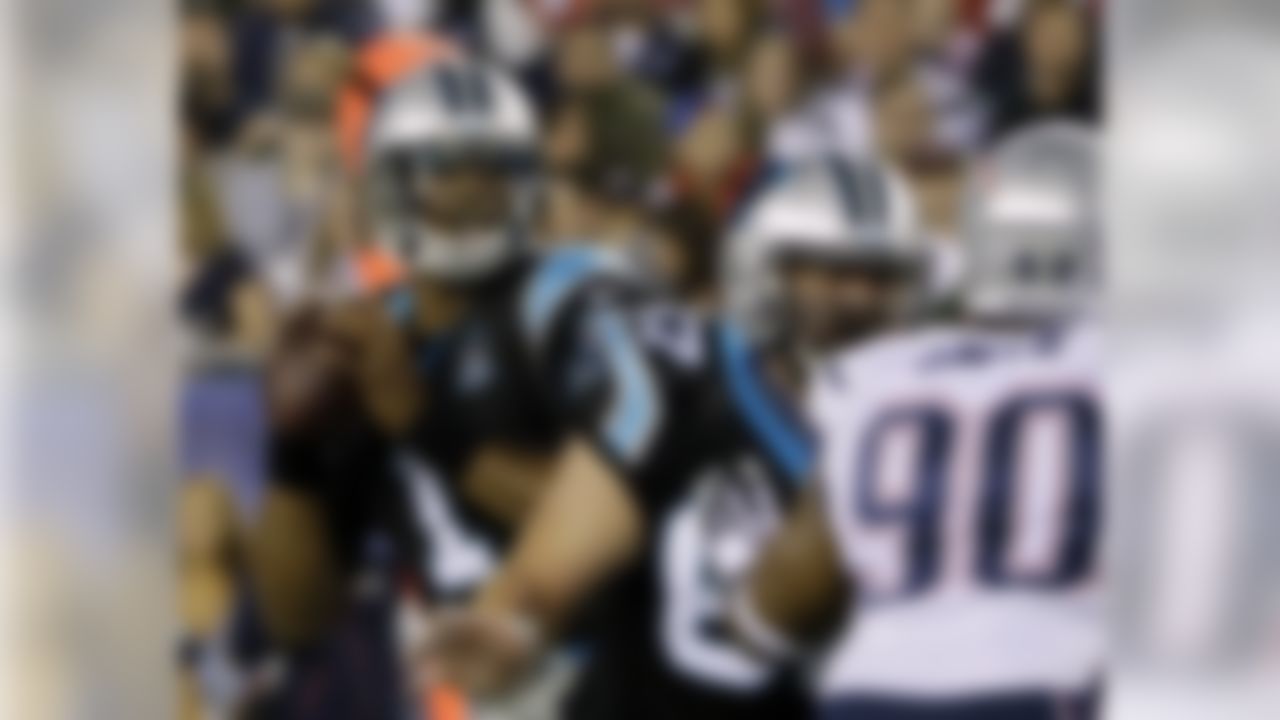 Carolina Panthers quarterback Cam Newton, left, looks for a receiver against a rush by New England Patriots defensive end Will Smith (90) in the first half of an NFL preseason football game Friday, Aug. 22, 2014, in Foxborough, Mass. (AP Photo/Stephan Savoia)