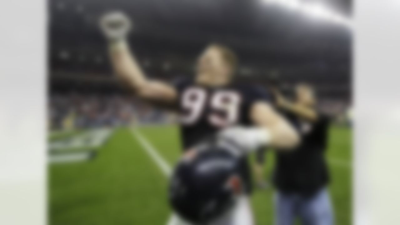 Houston Texans' J.J. Watt (99) celebrates after winning an NFL wild card playoff football game against the Cincinnati Bengals Saturday, Jan. 7, 2012, in Houston. The Texans won 31-10. (AP Photo/Tony Gutierrez)