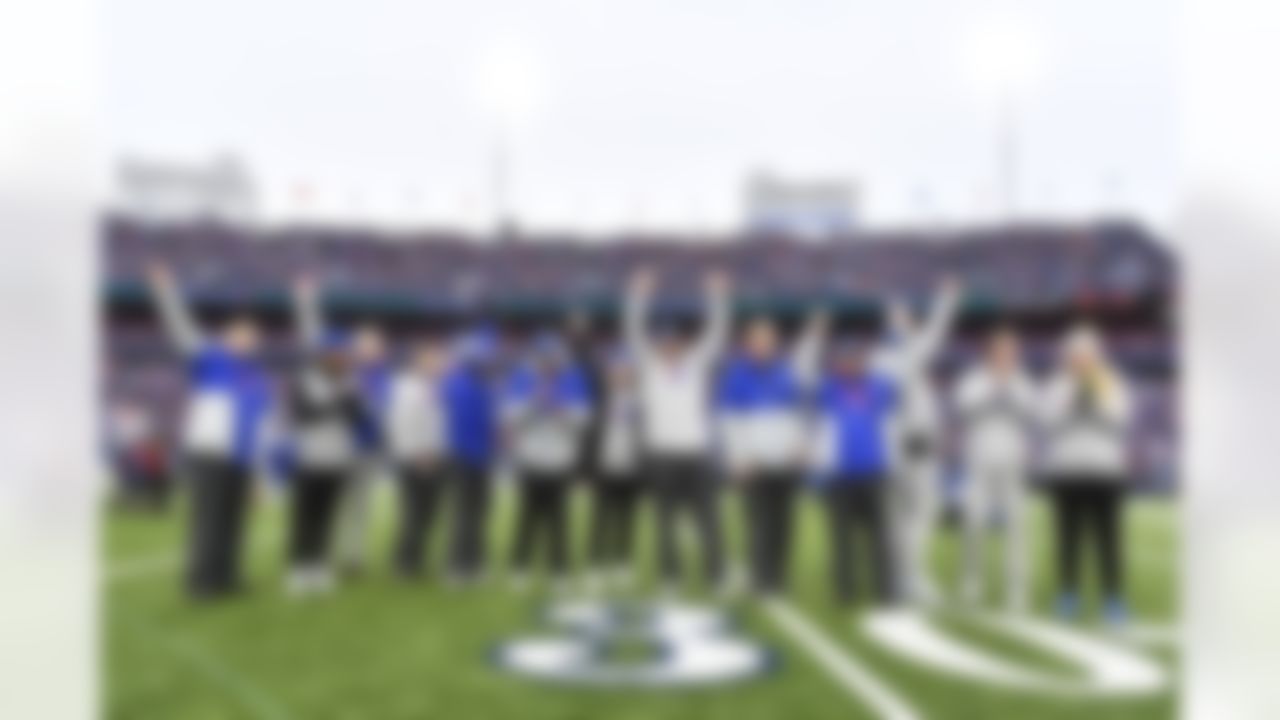The Buffalo Bills medical team waves to cheering fans before an NFL football game against the New England Patriots, Sunday, Jan. 8, 2023, in Orchard Park, N.Y.