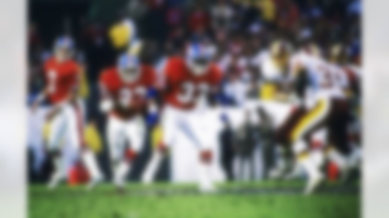 Denver Broncos running back Sammy Winder (23) takes the handoff from Hall of Fame quarterback John Elway (7) and follows the blocking of back Gene Lang (33) during Super Bowl XXII, a 42-10 loss to the Washington Redskins on January 31, 1988, at Jack Murphy Stadium in San Diego, CA. (National Football League)