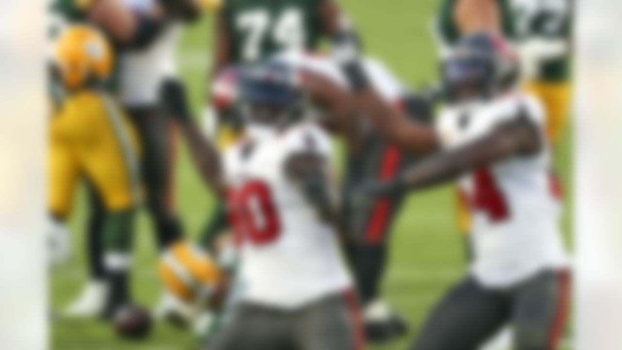 Tampa Bay Buccaneers outside linebacker Jason Pierre-Paul (90) and inside linebacker Lavonte David (54) celebrate after sacking Green Bay Packers quarterback Aaron Rodgers (12) during the second half of an NFL football game Sunday.