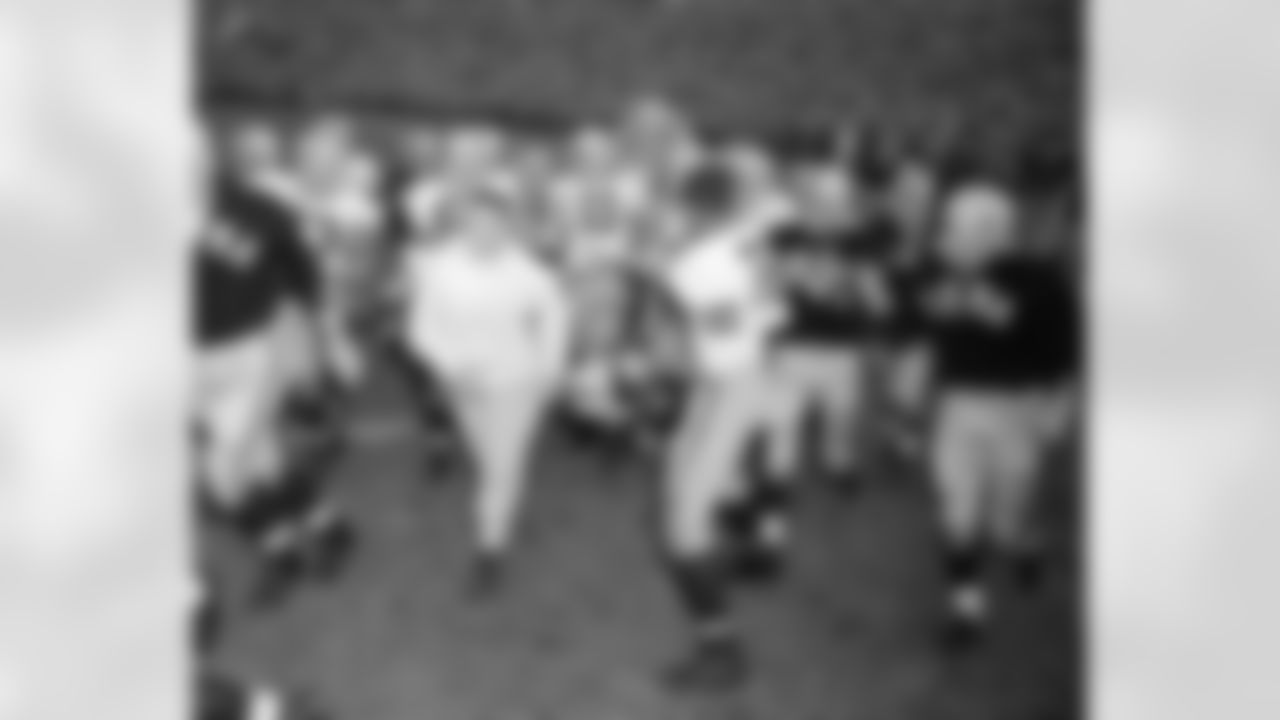 Jubilant Iowa players carry coach Forest Evashevski off the field on their shoulders after a 7-0 upset victory over Minnesota in Minneapolis, Nov. 10, 1956. Players include Alex Karras (77), John Burroughs (72), Dick Klein (70), Marion Walker (31), Dick Theer (62), and Ken Ploen (11). (AP Photo/Charles Knoblock)