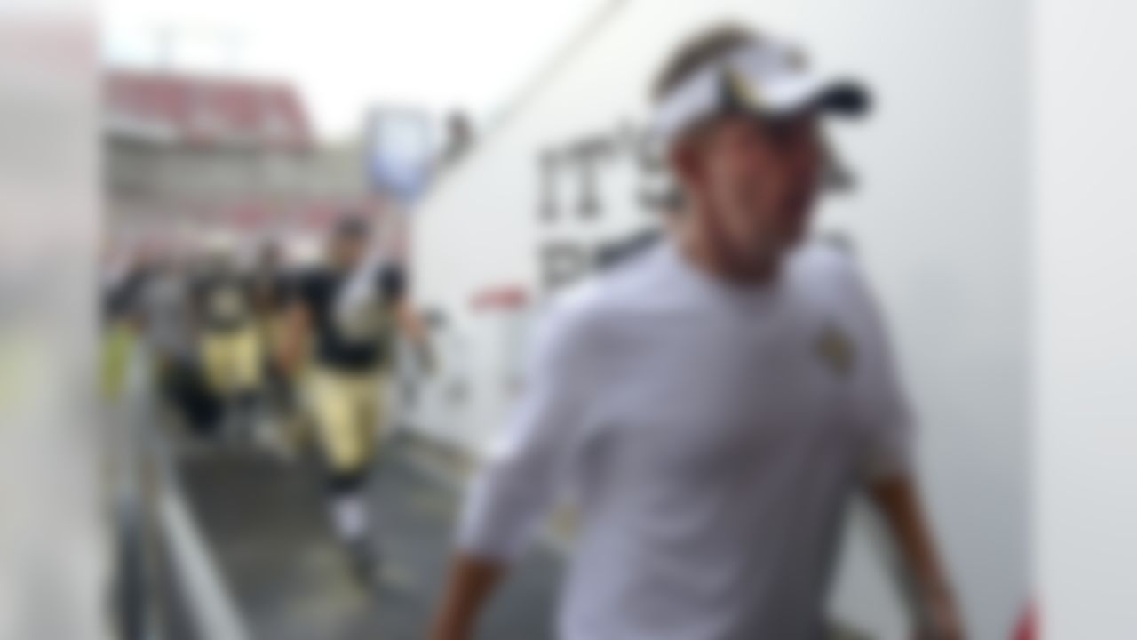 New Orleans Saints head coach Sean Payton, right, leaves the field after lightning forced a weather delay during the first half of an NFL football game against the Tampa Bay Buccaneers in Tampa, Fla., Sunday, Sept. 15, 2013. (AP Photo/Phelan M. Ebenhack)